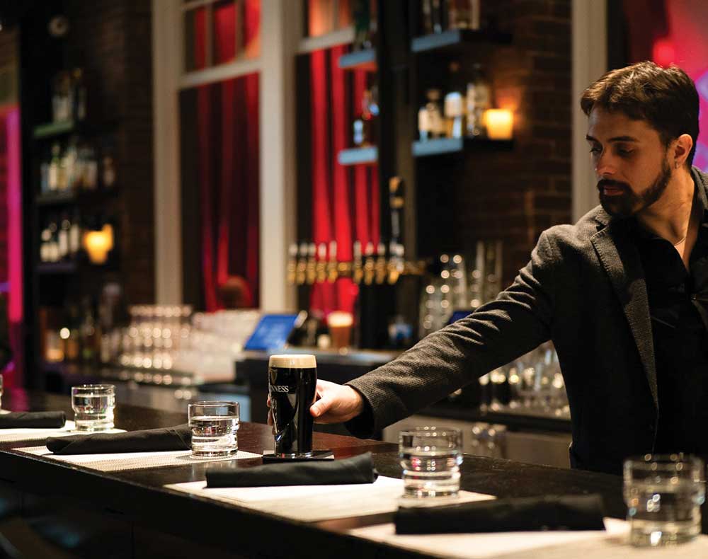 Bartender puts a beer on the bar at Jimmy's Jazz & Blues Club.
