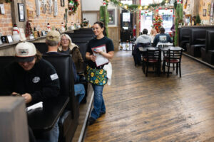 Servers wait on customers during lunch at Ky's American Bistro in downtown New Castle, Indiana.
