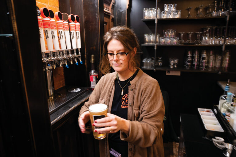 A bartender pours beers at Bad Dad Pizzeria & Taproom in downtown Richmond, Indiana.