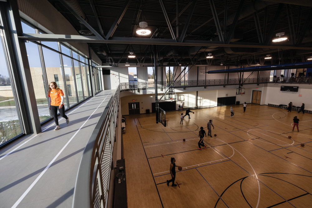 Members walk around the track above the basketball courts at the brand new YMCA in downtown Muncie, Indiana.