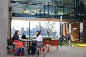 Students meet outdoors with a view of Manhattan at Stevens Institute of Technology in Hoboken, NJ