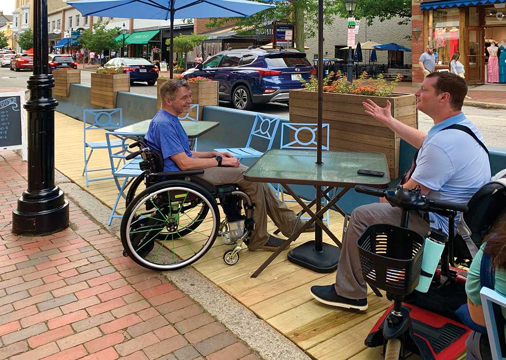 People talking at an outdoor restaurant.