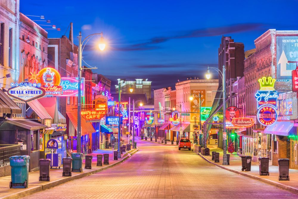 Vibrant neon signs of music clubs and restaurants along historic Beale Street in Memphis Tennessee.