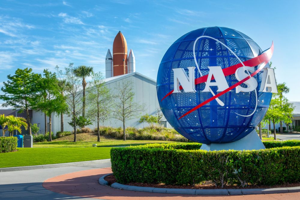 The iconic blue NASA logo at the entrance gates of the Kennedy Space Center Visitor Complex.