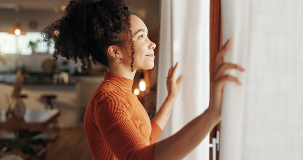 photo of woman looking out of a window