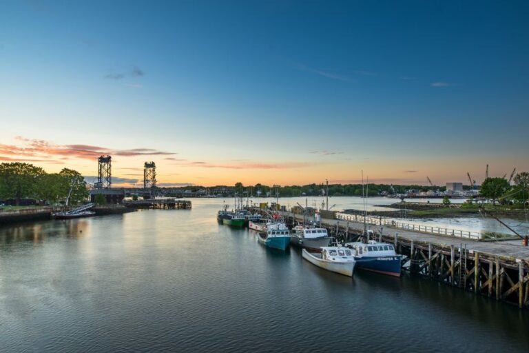 A view of boats on the water with the large metal structure of the Memorial Bridge in Portsmouth NH.