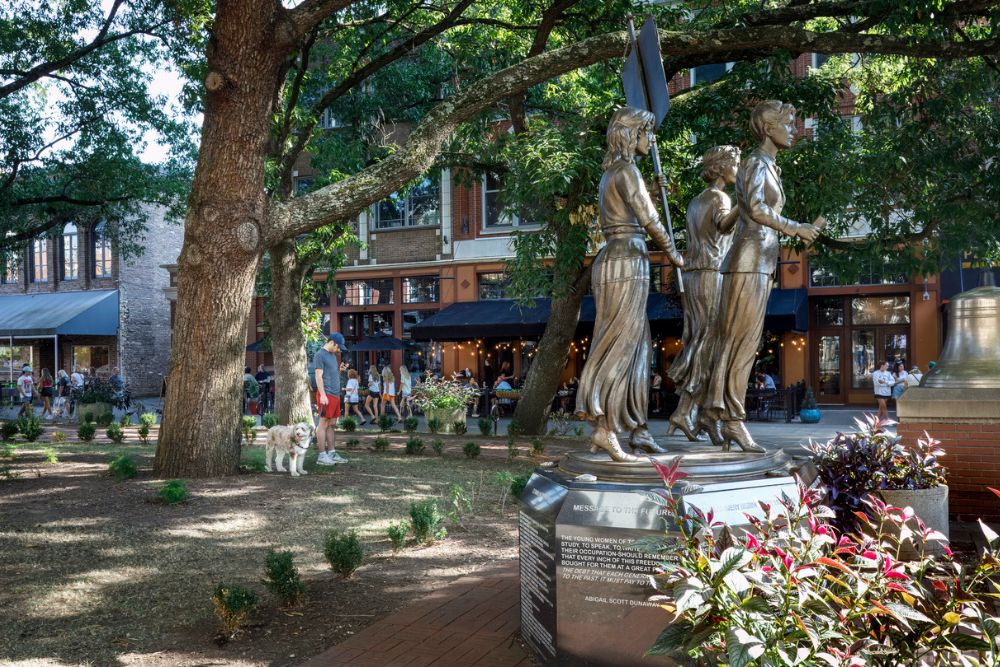 The bronze Tennessee Woman Suffrage Memorial statue standing in Market Square Knoxville.
