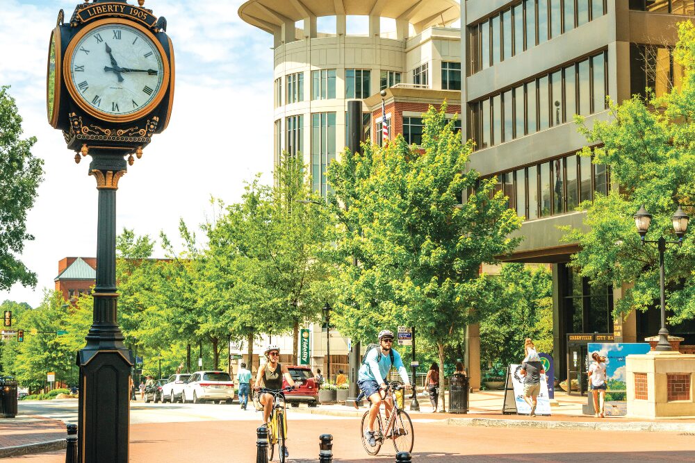 People riding bikes through downtown Greenville SC