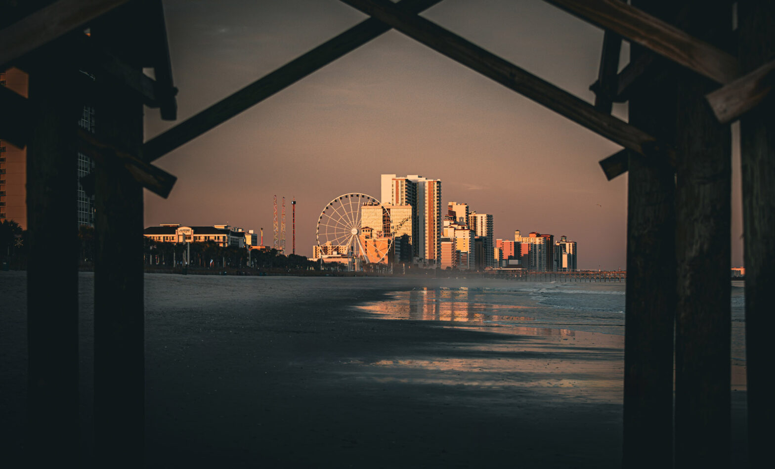 Scenic Myrtle Beach framed by a wooden bridge truss