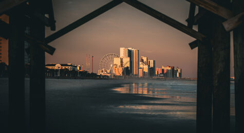 Scenic Myrtle Beach framed by a wooden bridge truss