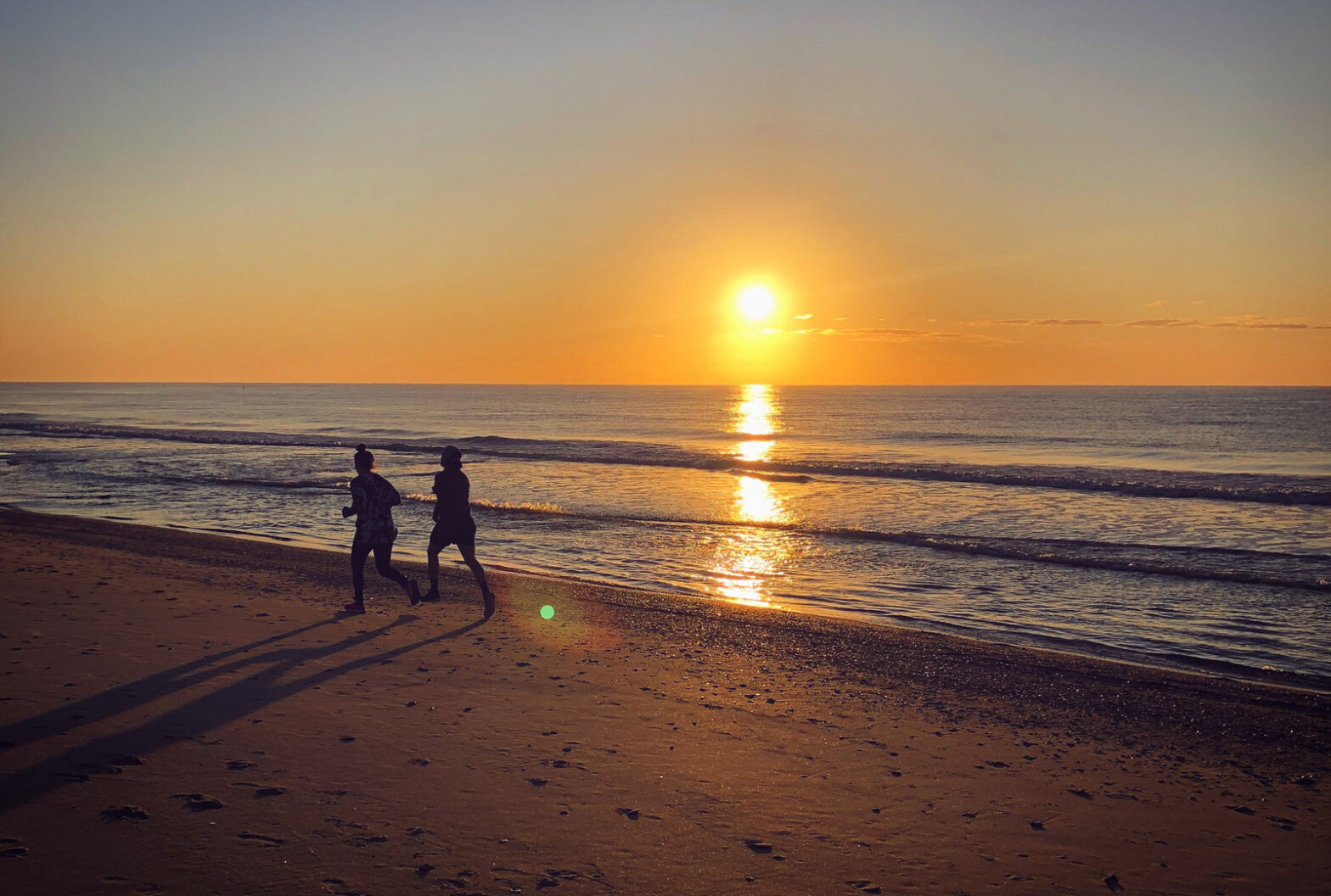 Two people jogging on Myrtle Beach at sunrise