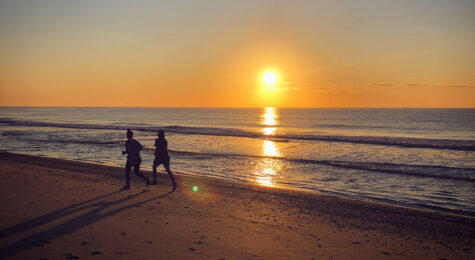 Two people jogging on Myrtle Beach at sunrise