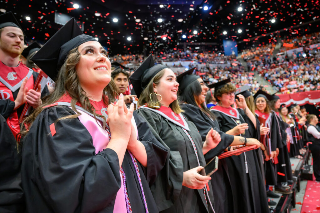 New graduates watch falling confetti at the conclusion of the 11:30am Spring Commencement Ceremony on the campus of Washington State University.