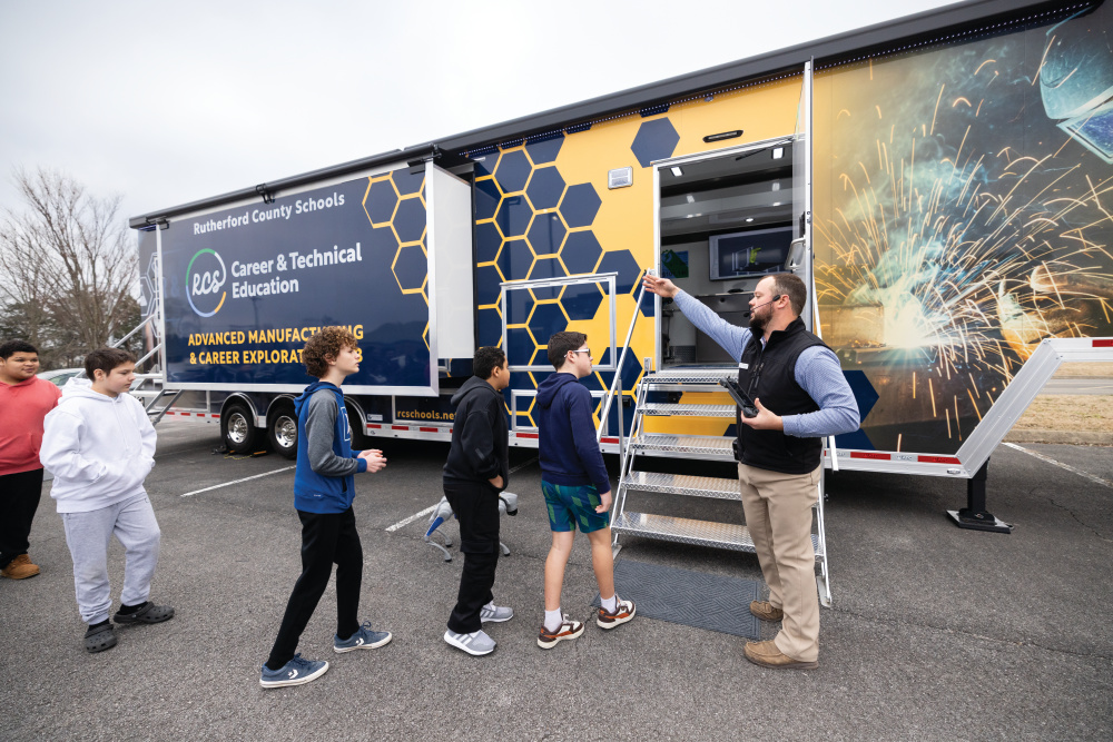 Brandon Stewart, right, leads students into one of their mobile learning labs at Whitworth Buchanan Middle School.