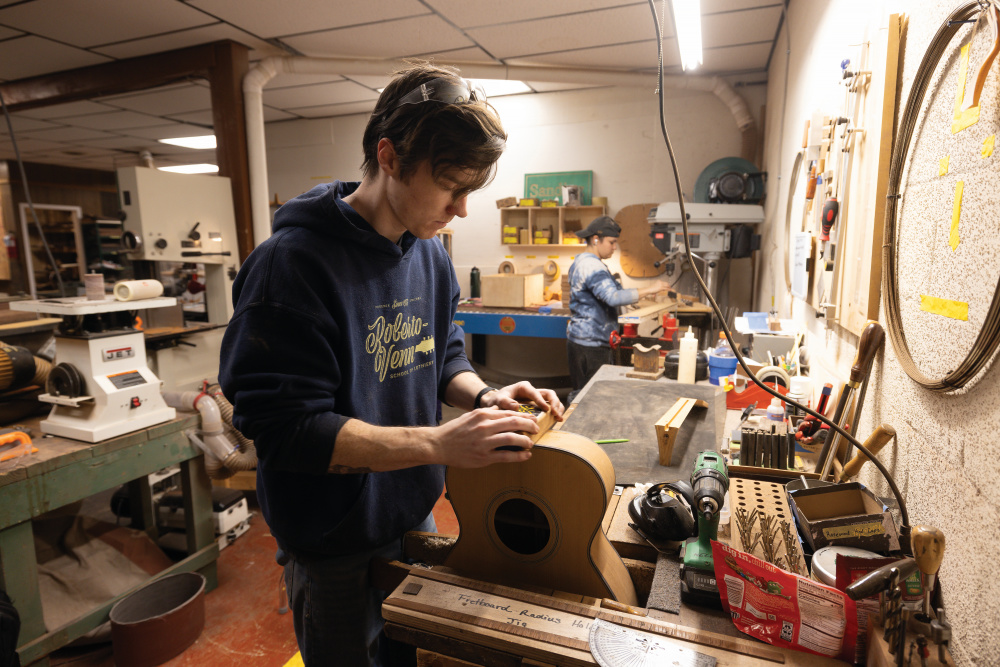 Garrett Case works on a Doc Watson style guitar at Gallagher Guitars in Murfreesboro.