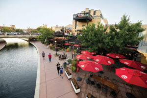 Visitors walk along the Pueblo Riverwalk past Brues Alehouse Brewing Company in downtown Pueblo, Colorado.