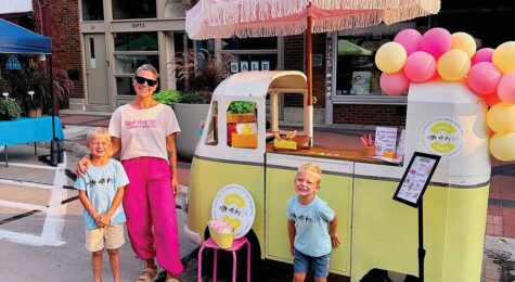 Britt Stormer and her children posing by the Letter Eats by B food cart in Ames Iowa.