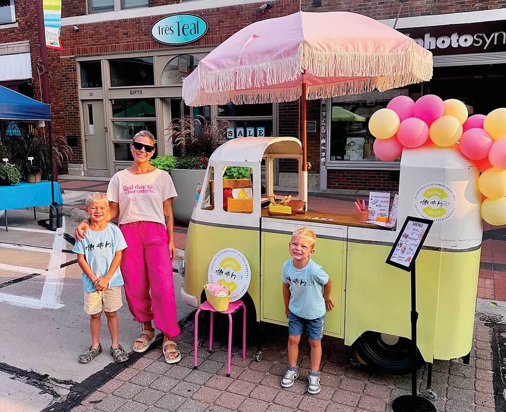 Britt Stormer and her children posing by the Letter Eats by B food cart in Ames Iowa.
