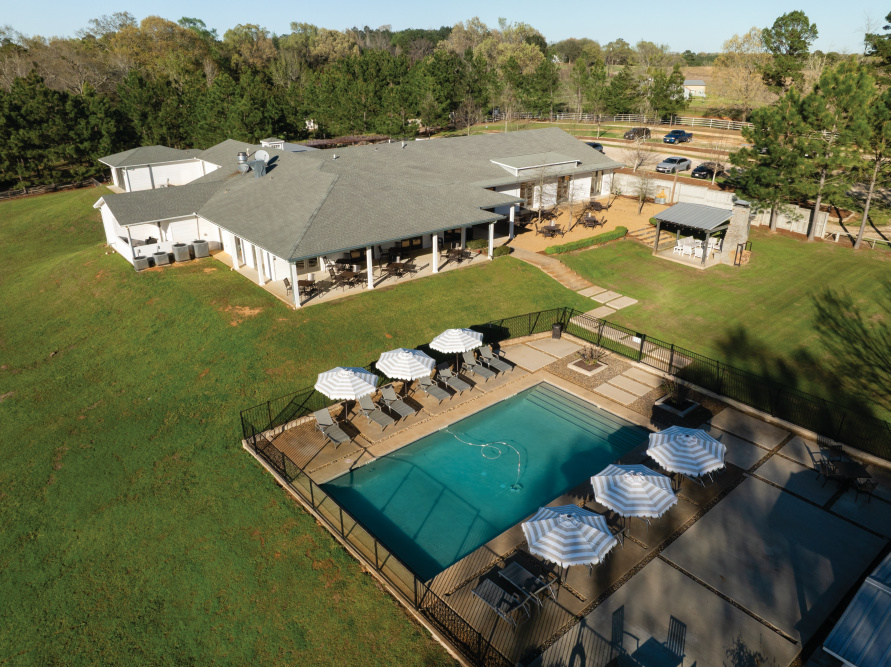 Aerial views of the main lodge and swimming pool at High Hill Resort in Arp, Texas.