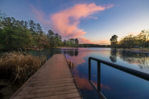 The sun sets over the lake at Tyler State Park in Tyler, Texas.