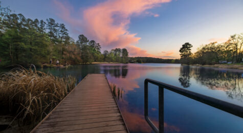The sun sets over the lake at Tyler State Park in Tyler, Texas.