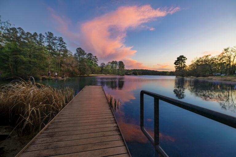 The sun sets over the lake at Tyler State Park in Tyler, Texas.