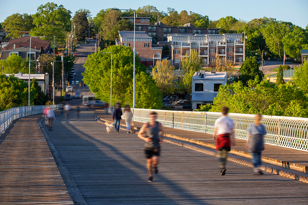 Visitors enjoy the outdoors in the warm spring weather while spending time on the Walnut Street Bridge, which connects the Northshore neighborhood to downtown Chattanooga, Tennessee.