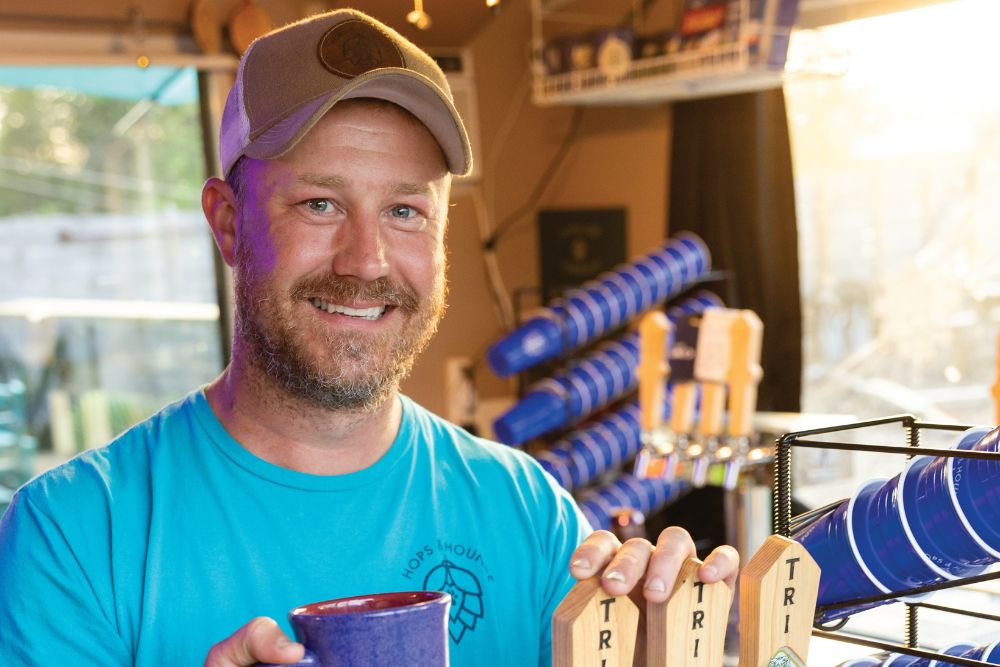 Co-owner Bela Parrott pours a beer Hops & Hounds dog park and beer garden in Oak Ridge, Tennessee.