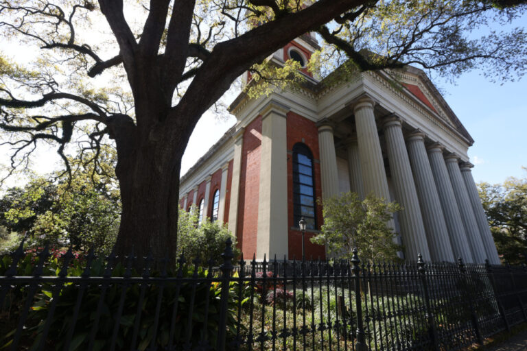 A massive oak trees grows next to the Cathedral - Basilica of the Immaculate Conception in downtown Mobile along the Alabama Dora Franklin Finley African American Heritage Trail in downtown Mobile, Alabama.
