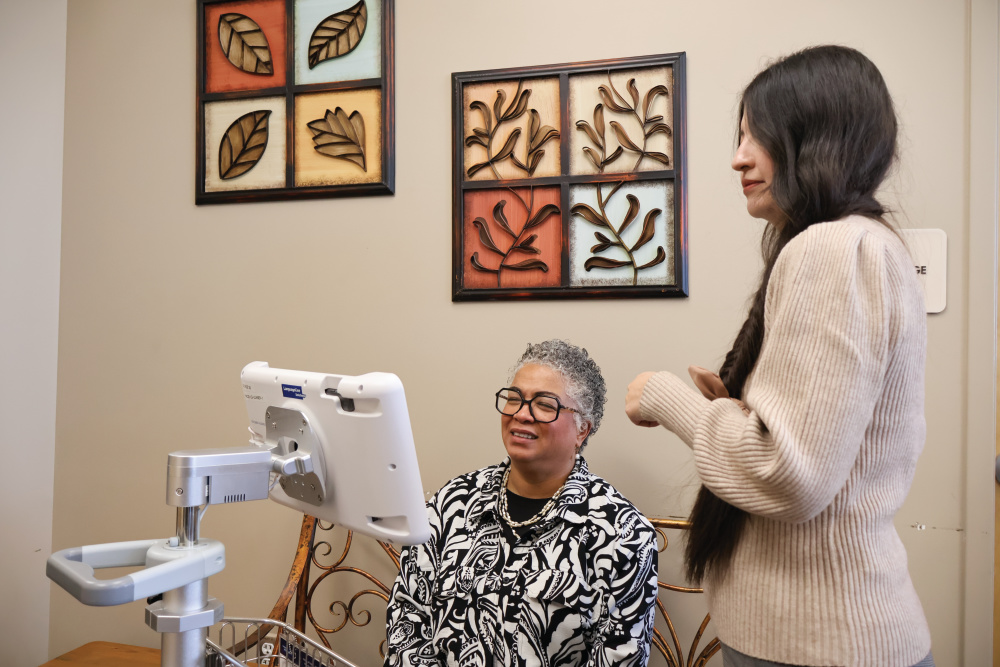 Emerald Oport, right, works as the coordinator of interpreter services for UCHealth.