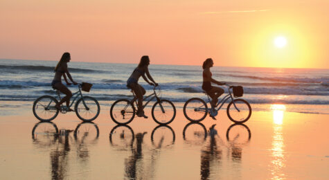 people biking on Daytona Beach