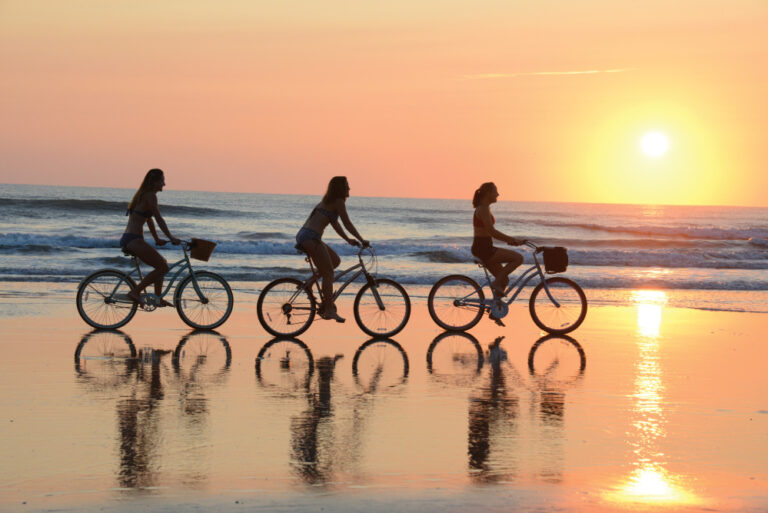 people biking on Daytona Beach