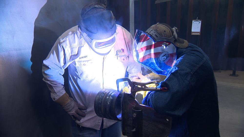 Jeremy Meyers, a UA & AWS-certified welding instructor, works with a pipe fabricator in preparation for upcoming welding certification testing.