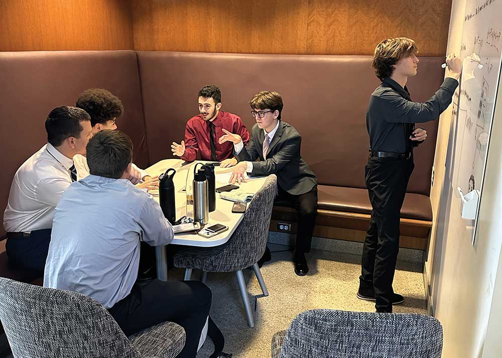 Gilbert High School DECA students practicing business presentations in Iowa.