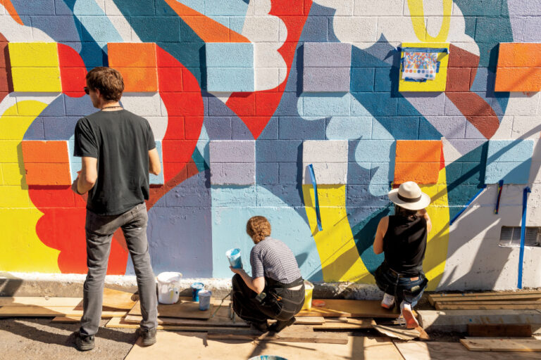 Artists from WSU work on painting the downtown wall mural project near the campus of Washington State University, Friday, September 24, 2021.