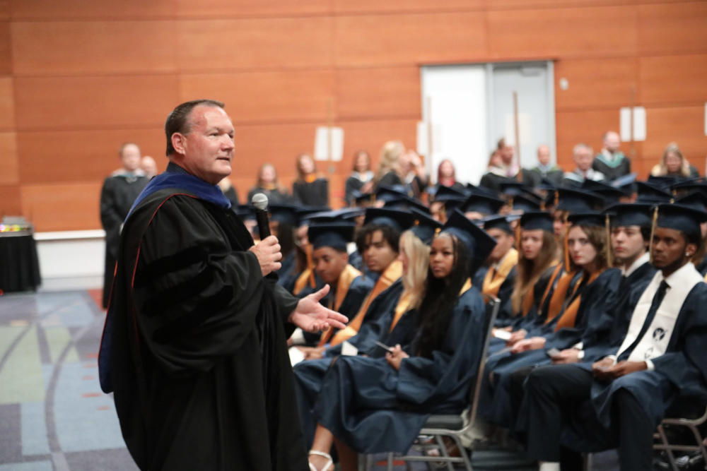 Dr. Robertson apeaking to students at graduation.