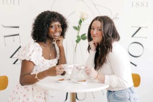 Women drink tea at Juniper and Olive Co restaurant interior Parisian bistro style Jewell Iowa.