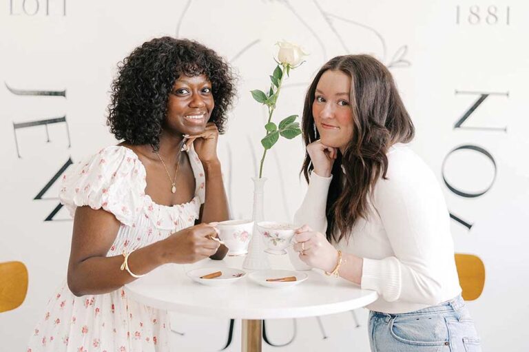 Women drink tea at Juniper and Olive Co restaurant interior Parisian bistro style Jewell Iowa.