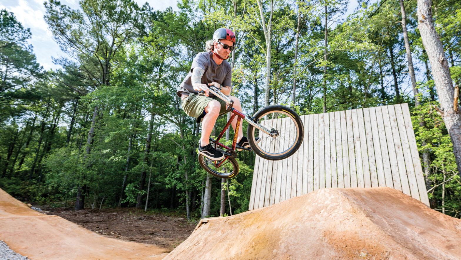 A man catches some air on his bicycle the Chris Smith Mountain Biking Trails at Wildwood Park in Greenville, NC.
