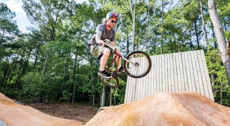A man catches some air on his bicycle the Chris Smith Mountain Biking Trails at Wildwood Park in Greenville, NC.
