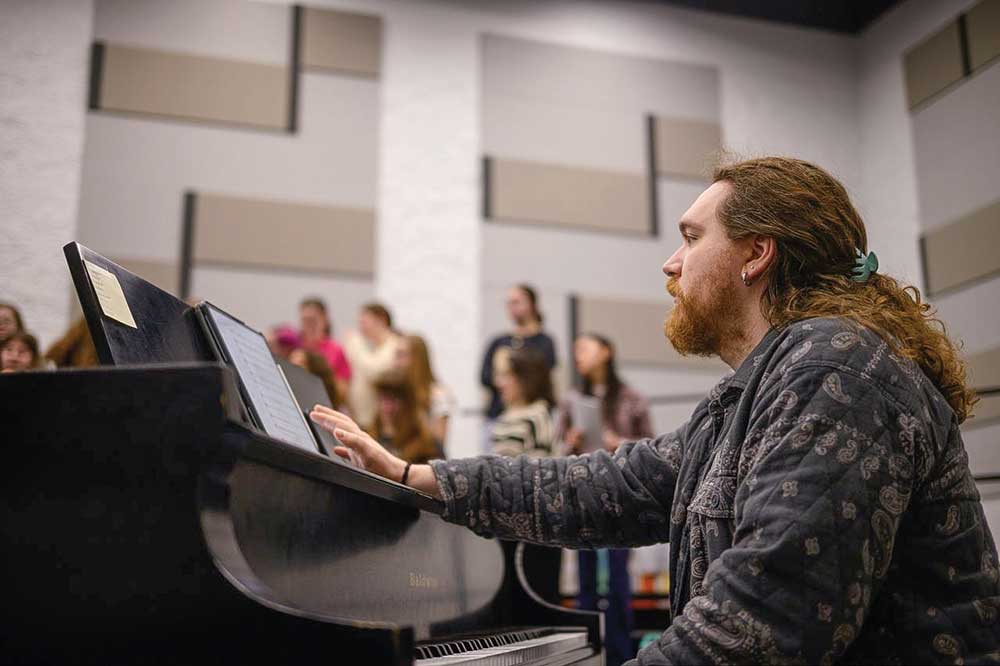 Aaron Lott playing a grand piano at Lott Music Studio in Ames Iowa