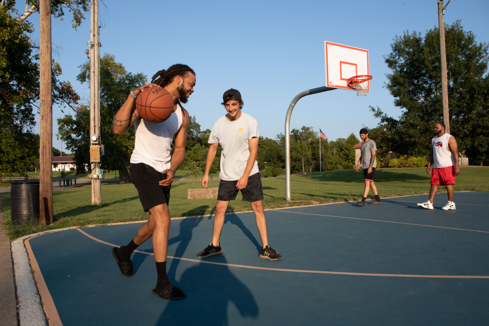 Aaron Eldridge, left, and Allen Gezelman play basket ball at Riverwalk Park.
