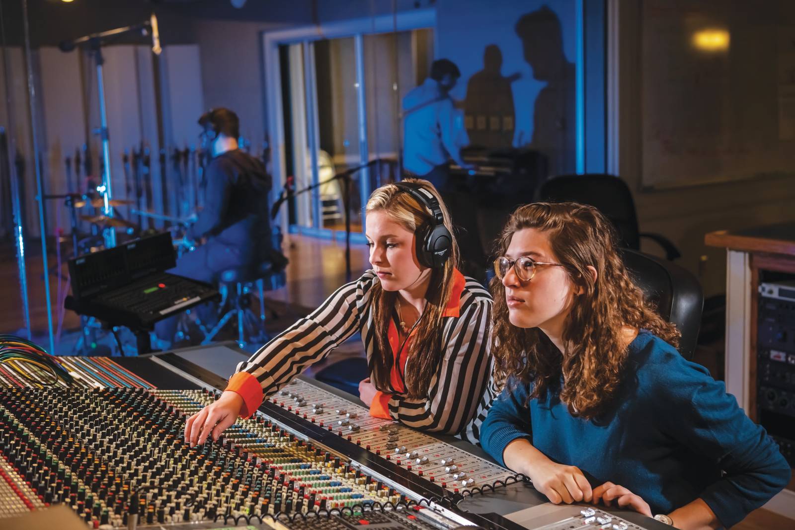 Students at an audio mixing board at Belmont University