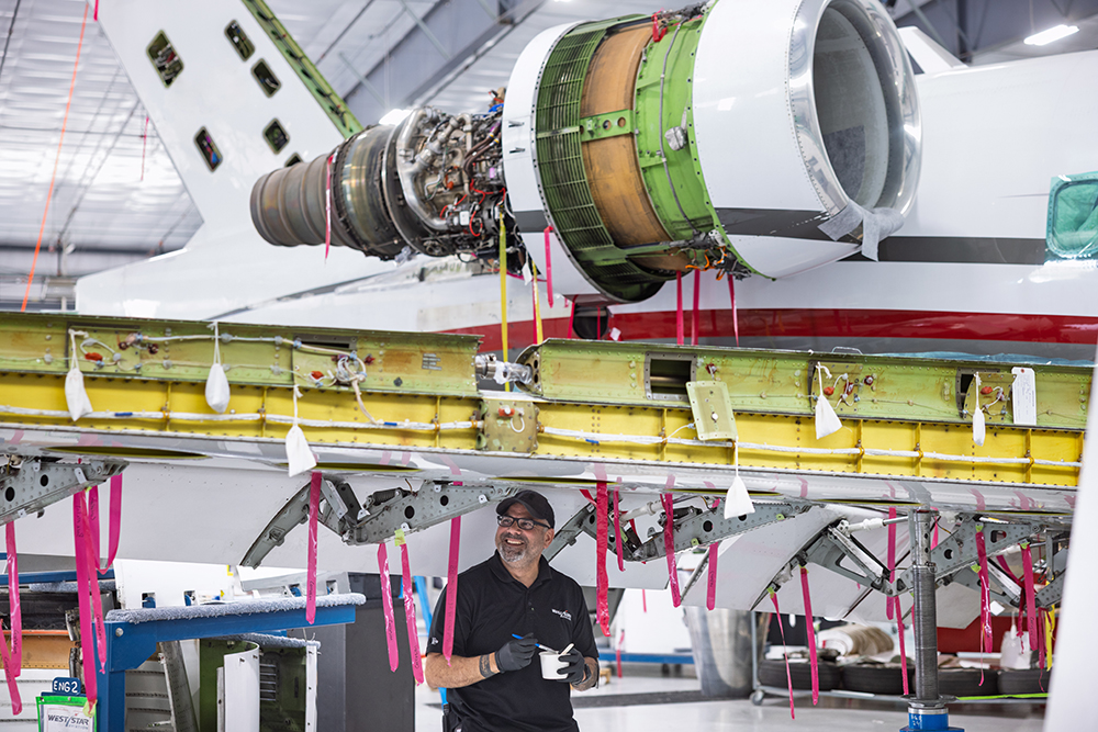 An employee puts some touch-up paint under a wing at West Star Aviation at Chattanooga Metropolitan Airport in Chattanooga, TN.