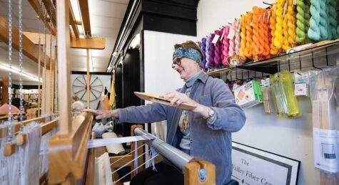 Leslie Fesperman weaves a design on a loom at the Yadkin Valley Fiber Center in Elkin.