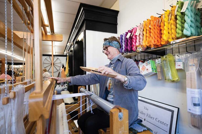 Leslie Fesperman weaves a design on a loom at the Yadkin Valley Fiber Center in Elkin.