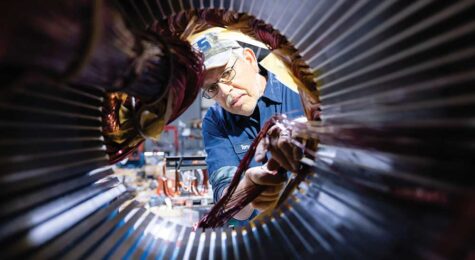 Tony Lowe replaces the electric coils in an industrial motor at AES in Mount Airy.