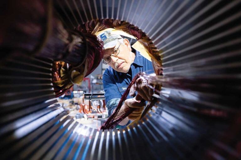 Tony Lowe replaces the electric coils in an industrial motor at AES in Mount Airy.