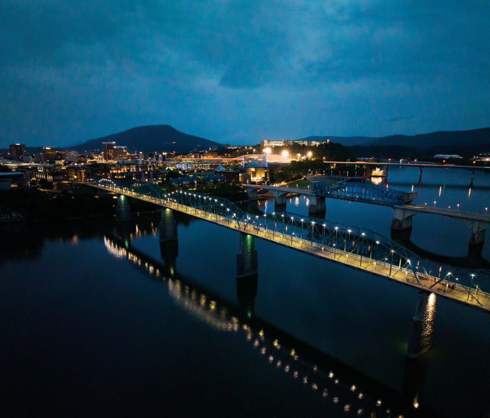 An aerial view of the Walnut Street Bridge which crosses the Tennessee River at dusk in downtown Chattanooga, TN.