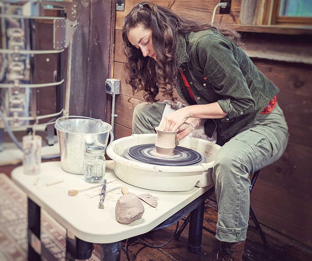Student practices pottery at the Foothills Art Center in Surry County, NC.